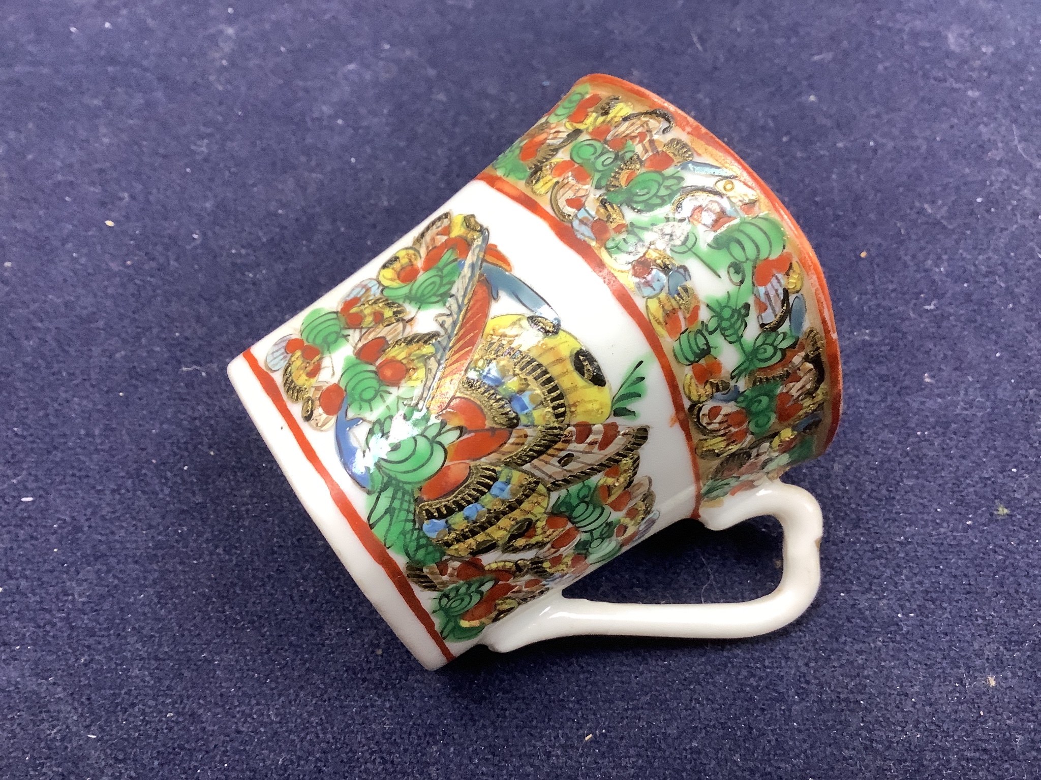 A Chinese famille rose small vase and two cups and saucers